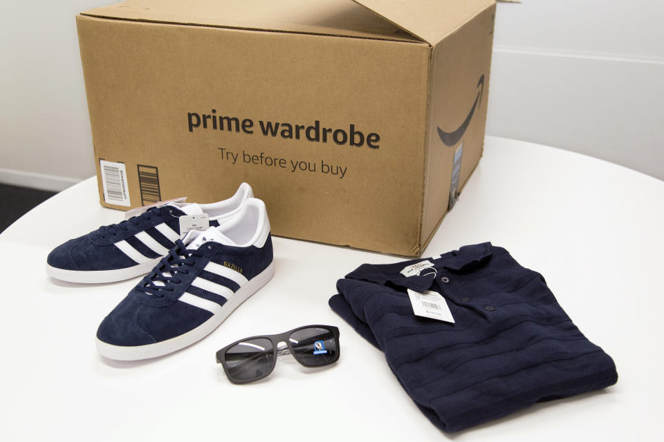 FILE - In this April 12, 2018 file photo, items ordered through Prime Wardrobe are displayed in New York. Amazon hopes to turn your home into a fitting room, after shipping you a box of fashions to try on before paying. It sounds a lot like Stitch Fix, Trunk Club or other services that send clothing in a box. But there are differences: There are no stylists with Prime Wardrobe, so you'll have to pick out your own shirts or skirts.  (AP Photo/Mark Lennihan, File)