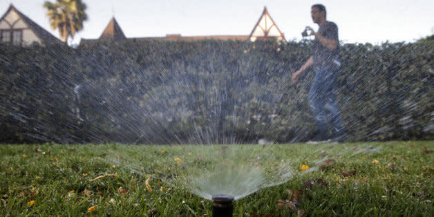 In this Friday, June 5, 2015, photo, Tony Corcoran records sprinklers watering the lawn in front of a house in Beverly Hills, Calif. Corcoran is one of several people who spend their spare time these days canvassing the tony communities of Beverly Hills, West Hollywood and elsewhere, looking for people wasting water during the worst California drought in recent memory. (AP Photo/Jae C. Hong) (Photo: )