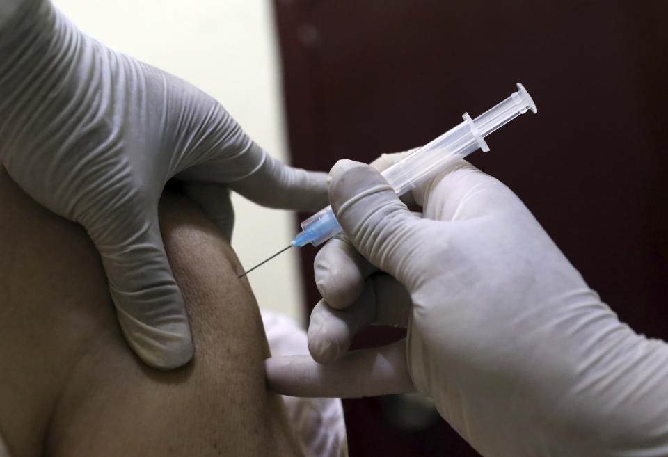 A man receives the Sinopharm COVID-19 vaccine at a vaccination center, in Kabul, Afghanistan, Wednesday, June 16, 2021. In Afghanistan, where a surge threatens to overwhelm a war-battered health system, 700,000 doses donated by China arrived over the weekend, and within hours, "people were fighting with each other to get to the front of the line," said Health Ministry spokesman Dr. Ghulam Dastigir Nazari. (AP Photo/Rahmat Gul)