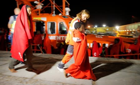 Migrants disembark from a rescue boat at the port of Malaga