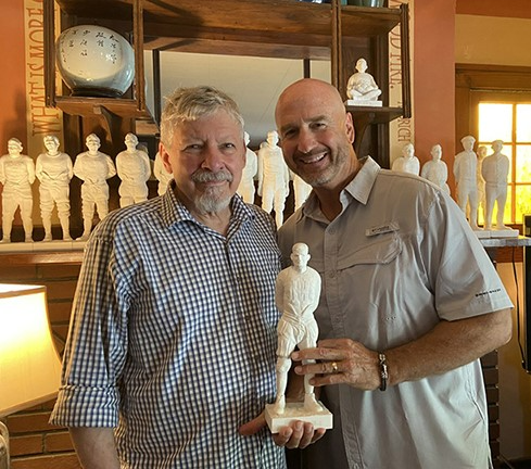 Local artist Ray Sokolowski (left) with John Wayhart, who's holding a sculpture of his grandfather, Frank Wayhart, who played on a football team with Pittsburgh Steelers founder Art Rooney.