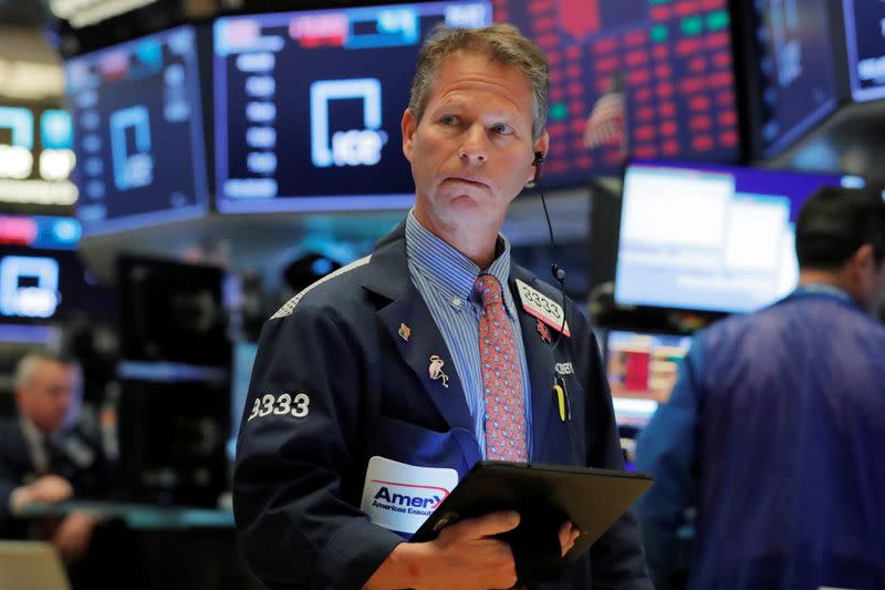 A trader works on the floor of the New York Stock Exchange shortly after the opening bell in New York
