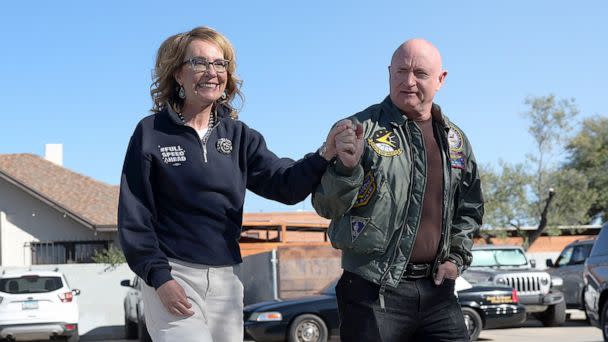 PHOTO: Sen. Mark Kelly and his wife former Rep. Gabby Giffords talk to campaign volunteers on Election Day in Tuscon, Ariz., Nov. 08, 2022. (Kevin Dietsch/Getty Images)