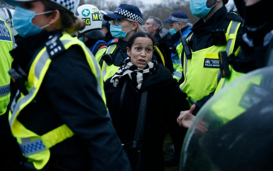 A woman is arrested by Met Police during a "World Wide Rally For Freedom" protest in London - Getty