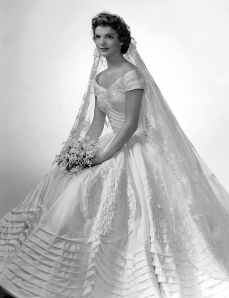 Bridal portrait of Jacqueline Lee Bouvier (1929 - 1994) shows her in an Anne Lowe-designed wedding dress, a bouquet of flowers in her hands, New York, New York, 1953. (Photo by Bachrach/Getty Images)