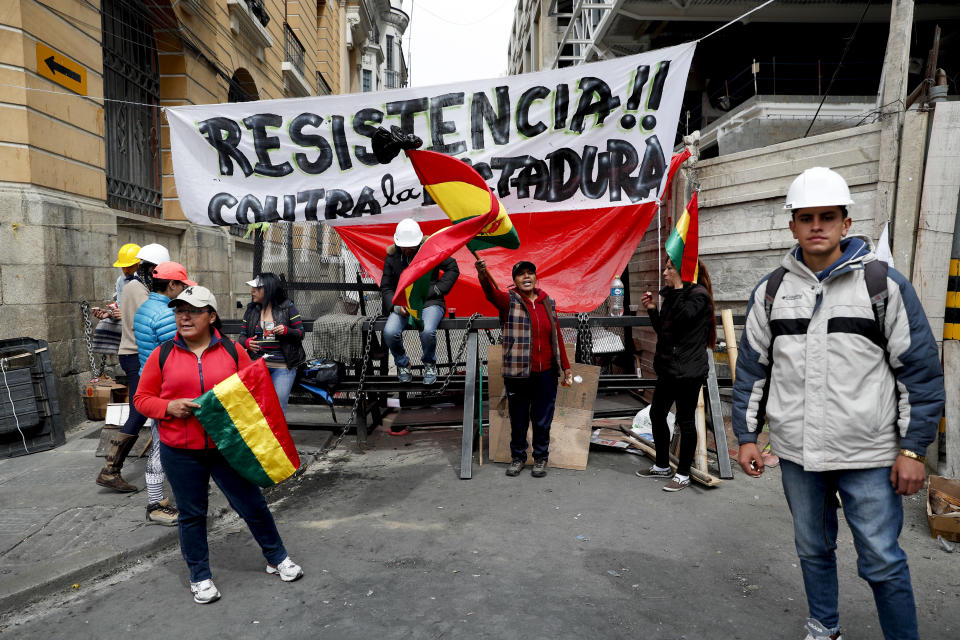 Anti-government protesters block a street meters away from the presidential palace in La Paz, Bolivia, Sunday, Nov. 10, 2019. President Evo Morales is calling for new presidential elections and an overhaul of the electoral system Sunday after a preliminary report by the Organization of American States found irregularities in the Oct. 20 elections. (AP Photo/Juan Karita)