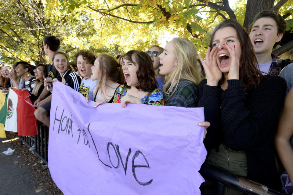 Deeda Browning corea consignas ante los automóviles que pasan en una protesta de estudiantes de la preparatoria Boulder High contra la elección de Donald Trump, el miércoles 9 de noviembre de 2016 en Boulder, Colorado. La manta dice “Toca la bocina al amor”. (Paul Aiken/Daily Camera vía AP)