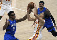 Atlanta Hawks guard Bogdan Bogdanovic (13) gets tangled up with Orlando Magic Wendell Carter Jr., (34) and guard Gary Harris, right, in the second half of an NBA basketball game Thursday, May 13, 2021 in Atlanta. The Hawks defeated the Magic 116-93. (AP Photo/Tami Chappel)