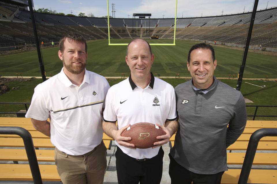 New Purdue Head Football Coach Jeff Brohm, center, is flanked by his brothers Brian Brohm, left, co-offensive coordinator/quarterbacks coach and Greg Brohm, executive director of administration and operations/chief of staff.  Jeff was formerly the head coach at Western Kentucky University and before that was offensive coordinator and assistant head coach at the University of Louisville.Apr. 25, 2017