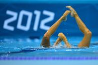 Canada's Elise Marcotte and Canada's Marie-Pier Boudreau Gagnon compete in the duets free routine preliminary round during the synchronised swimming competition at the London 2012 Olympic Games on August 6, 2012 in London. AFP PHOTO / FABRICE COFFRINIFABRICE COFFRINI/AFP/GettyImages