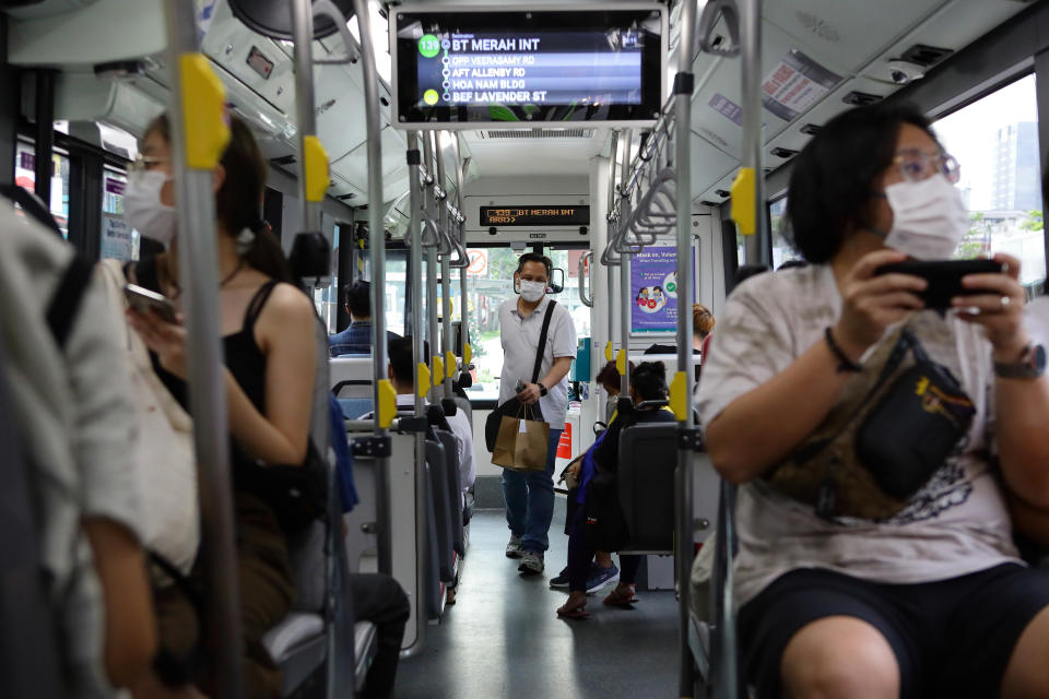 A man wearing protective mask boards a bus on December 20, 2021 in Singapore. (Photo by Suhaimi Abdullah/NurPhoto via Getty Images)