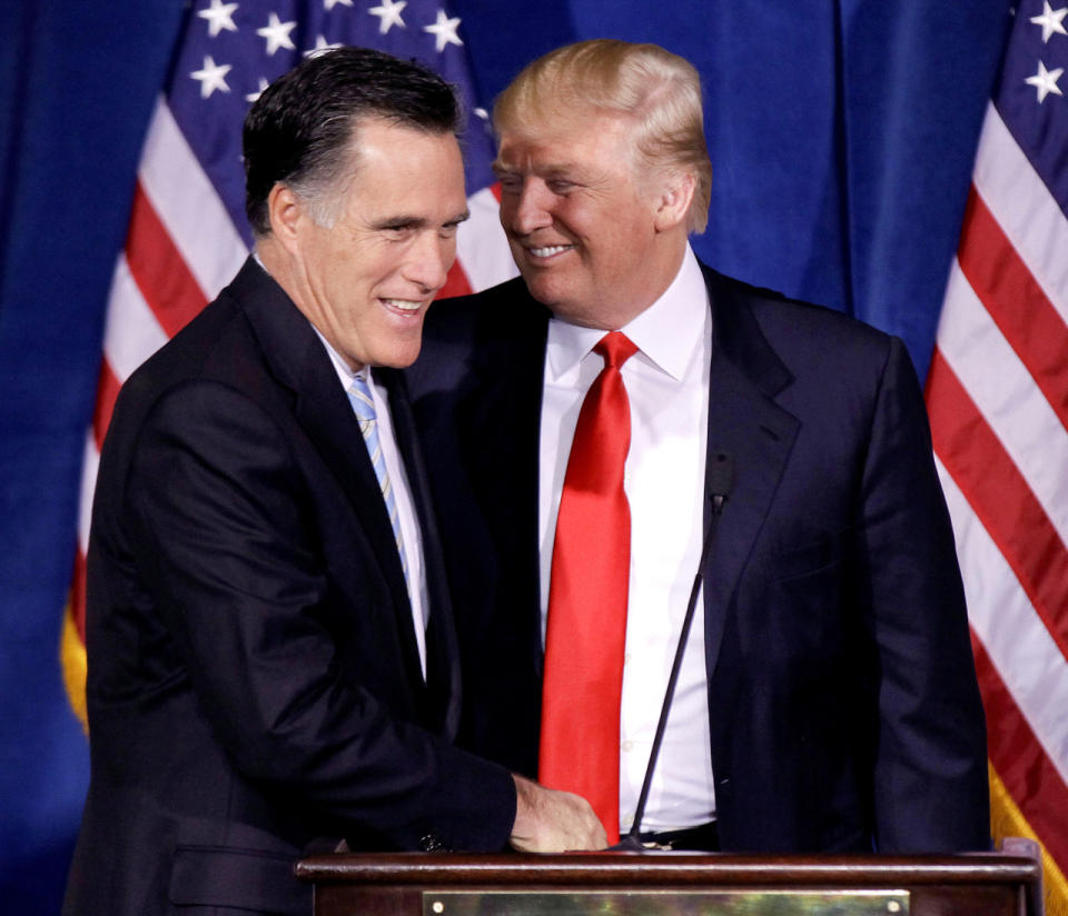 <p>Trump greets presidential candidate Mitt Romney during a news conference in Las Vegas in February 2012. <i>(Photo: Julie Jacobson/AP)</i> </p>