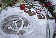 Pieces of bread and sugar at the Piskaryovskoye Cemetery where most of the Leningrad Siege victims were buried during World War II, in St.Petersburg, Russia, Saturday, Jan. 26, 2019. People gathered to mark the 75th anniversary of the battle that lifted the Siege of Leningrad. The Nazi German and Finnish siege and blockade of Leningrad, now known as St. Petersburg, was broken on Jan. 18, 1943 but finally lifted Jan. 27, 1944. More than 1 million people died mainly from starvation during the 900-day siege. (AP Photo/Dmitri Lovetsky)