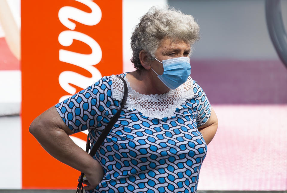 An old woman with mask walks through the city during the new Coronavirus disease (COVID-19) after the increase of coronavirus infected in Belgrade, Serbia on July 24, 2020. The number of coronavirus infections is increasing throughout Serbia, especially in Belgrade, where 80% of coronavirus infections are found. The government mandates the mandatory use of masks indoors and outdoors to halt the spread of the coronavirus disease (COVID-19).  (Photo by Nikola Krstic/NurPhoto via Getty Images)