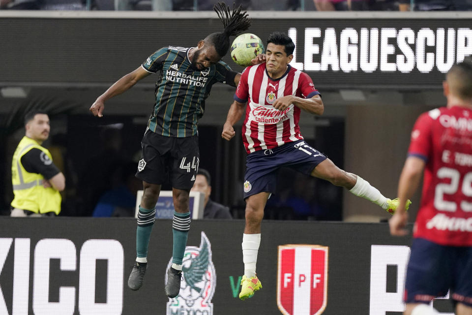Los Angeles Galaxy forward Raheem Edwards, left, and Chivas defender Jesus Sanchez try to head the ball during the first half of a Leagues Cup match Wednesday, Aug. 3, 2022, in Inglewood, Calif. (AP Photo/Mark J. Terrill)