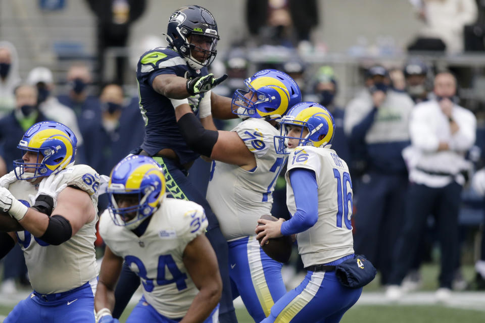 Los Angeles Rams quarterback Jared Goff (16) looks for room to pass against the Seattle Seahawks during the first half of an NFL wild-card playoff football game, Saturday, Jan. 9, 2021, in Seattle. (AP Photo/Scott Eklund)