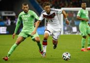 Algeria's Islam Slimani (L) fights for the ball with Germany's Mesut Ozil (in white) during their 2014 World Cup round of 16 game at the Beira Rio stadium in Porto Alegre June 30, 2014. REUTERS/Stefano Rellandini