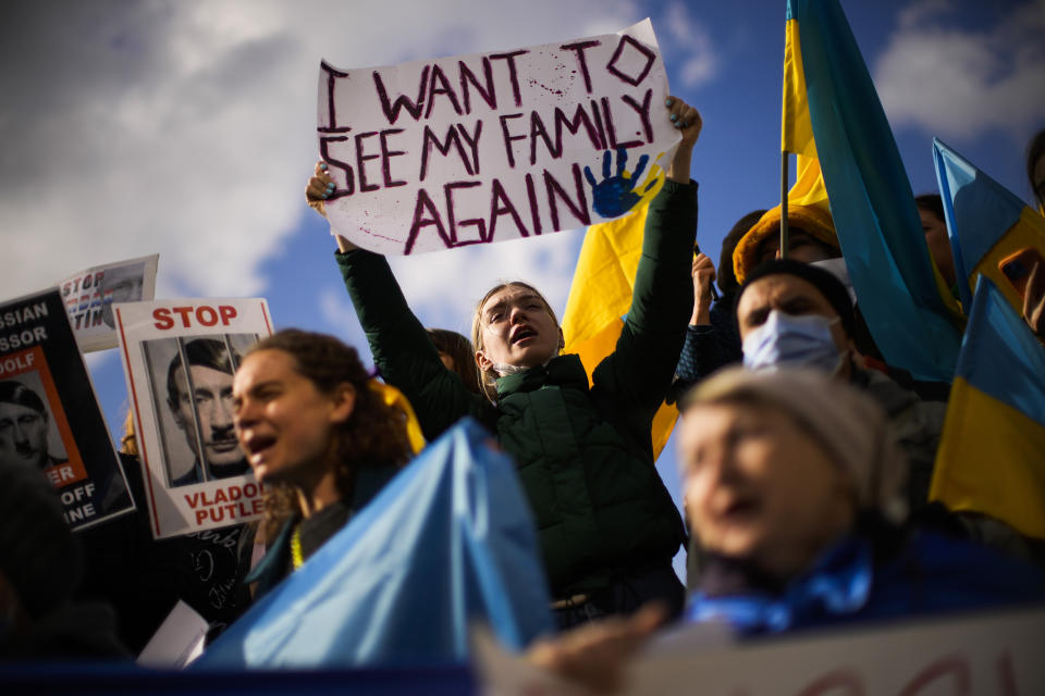 FILE - Pro-Ukrainian people hold up placards and wave Ukrainian flags as they shout slogans during a protest against Russia's invasion of Ukraine, in Istanbul, Turkey, Wednesday, March 2, 2022. As milestones go, the first anniversary of Russia's invasion of Ukraine is both grim and vexing. It marks a full year of killing, destruction, loss and pain felt even beyond the borders of Russia and Ukraine. (AP Photo/Francisco Seco, File)