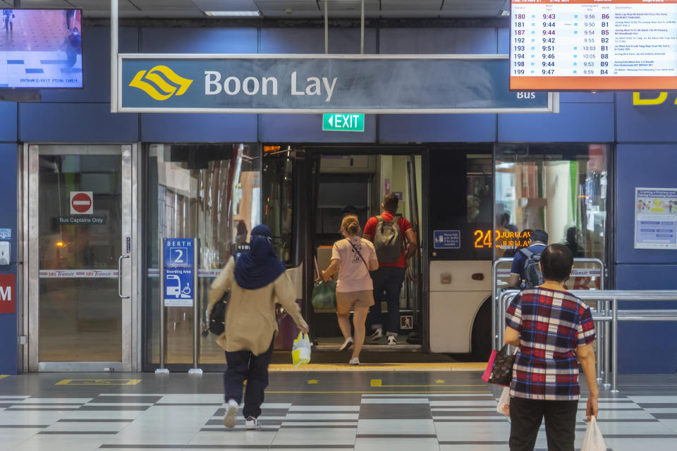 Commuters boarding a public bus at Boon Lay Bus Interchange. 