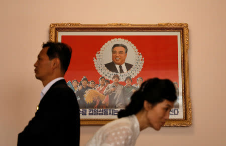 Guides walk past an image of late North Korean leader Kim Il Sung at a teachers' training college during a government organised visit for foreign reporters in Pyongyang, North Korea, September 7, 2018. REUTERS/Danish Siddiqui