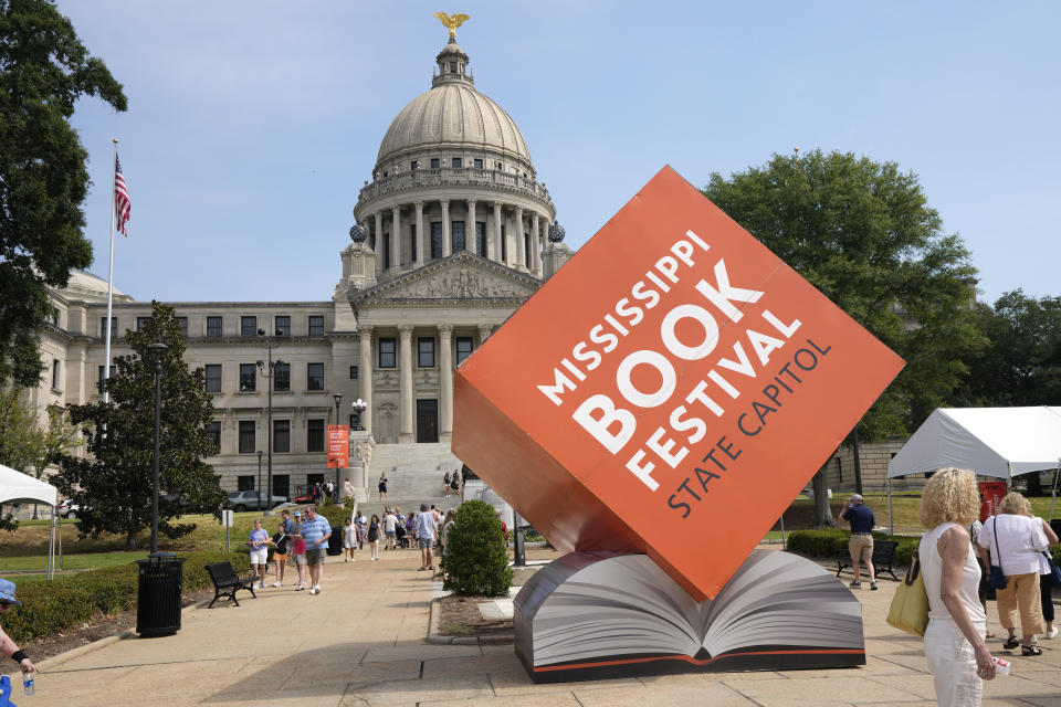 An oversized display touts the Mississippi Book Festival on the state Capitol grounds in Jackson, Miss., Saturday, Aug. 19, 2023. Several dozen authors participated in a variety of panels or sit-down interviews for festival attendees, in addition to selling their books. (AP Photo/Rogelio V. Solis)