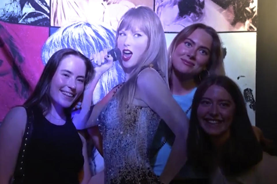 In this image taken from video, fans pose with a life-size image of Taylor Swift at a club that plays only Swift's music in Gothenburg, Sweden, on Tuesday, April 30th, 2024. Swift is scheduled to kick off the 18-city Europe leg of her record-setting Eras Tour on Thursday, May 9, 2024. There will be three shows in Stockholm. (AP Photo/Chisato Tanaka)