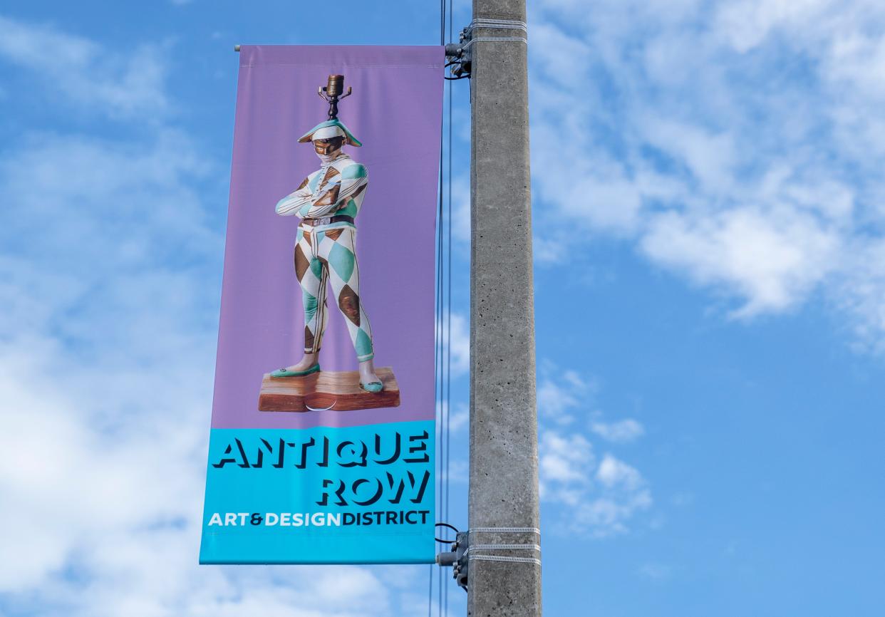 Signs welcome people to Antique Row in West Palm Beach, Florida on June 9, 2022. 