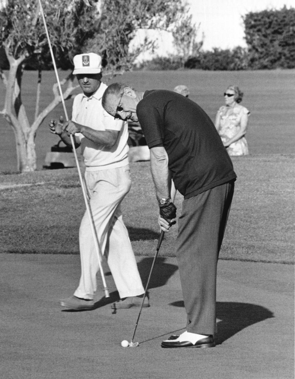 President Lyndon Johnson lines one up while golfing at Arizona Biltmore.