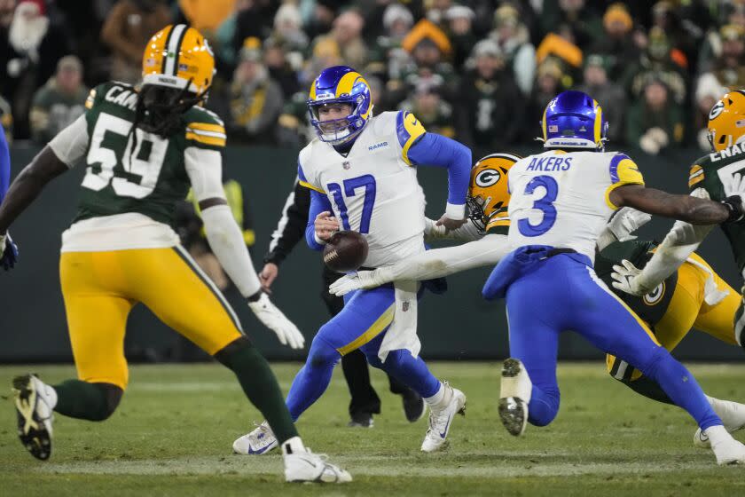 Los angles Rams quarterback Baker Mayfield (17) fumbles as he's hit by Green Bay Packers.
