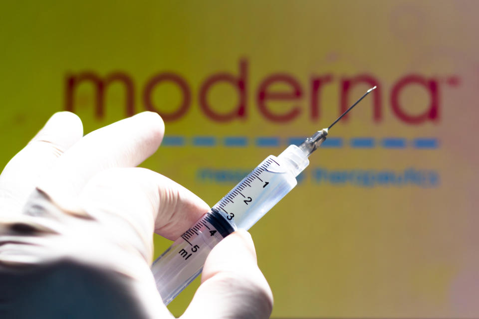In this photo illustration the medical syringe is seen with Moderna Therapeutics company logo displayed on a screen in the background (Photo by Rafael Henrique / SOPA Images/Sipa USA)