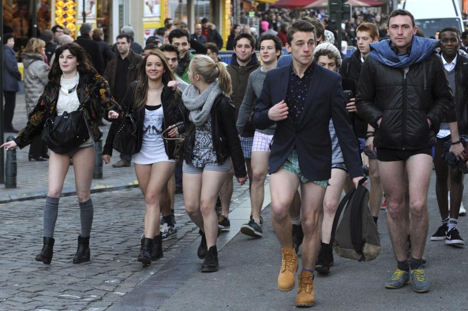 People take part in the annual "No Pants Subway Ride" celebrations on the streets of Brussels January 12, 2014. The event involves participants who strip down to their underwear as they go about their normal routine, and occurs in different cities around the world in January, according to its organisers. REUTERS/Eric Vidal (BELGIUM - Tags: TRANSPORT SOCIETY ANNIVERSARY)