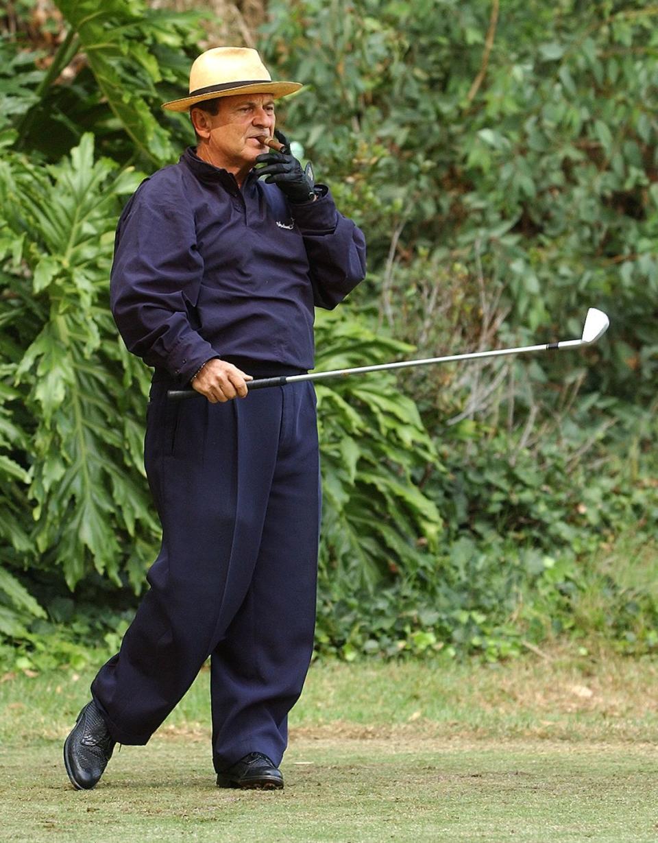 <p>Joe Pesci takes a drag from a cigar before hitting a shot in the 4th Annual Elizabeth Glaser Pediatric AIDS Foundation Celebrity Golf Classic in 2002. </p>