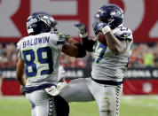 Seattle Seahawks running back Mike Davis (27) celebrates his touchdown with wide receiver Doug Baldwin (89) during the second half of an NFL football game against the Arizona Cardinals, Sunday, Sept. 30, 2018, in Glendale, Ariz. (AP Photo/Rick Scuteri)