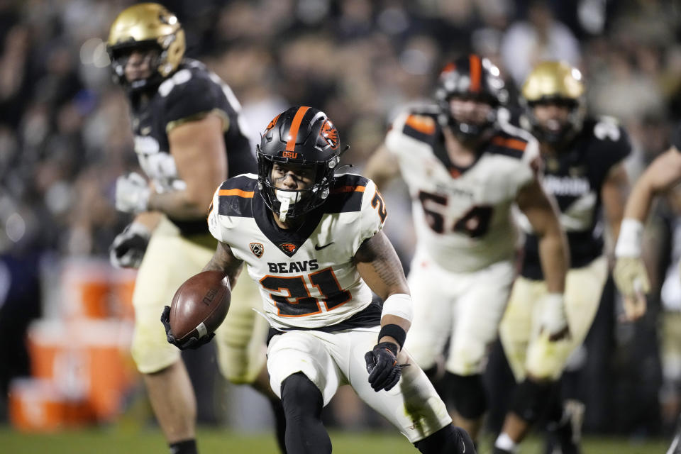 Oregon State running back Trey Lowe runs for a long gain in overtime of an NCAA college football game against Colorado, Saturday, Nov. 6, 2021, in Boulder, Colo. (AP Photo/David Zalubowski)