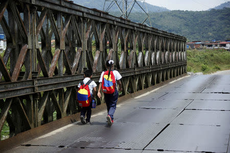 Children walk back home from school in San Cristobal, Venezuela February 22, 2018. REUTERS/Carlos Eduardo Ramirez/Files