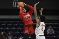 Stony Brook guard Tyler Stephenson-Moore (14) attempts a shot and is fouled by Charleston guard Khalil London (3) during the first half of an NCAA college basketball game in the championship of the Coastal Athletic Association conference tournament, Tuesday, March 12, 2024, in Washington. (AP Photo/Terrance Williams)