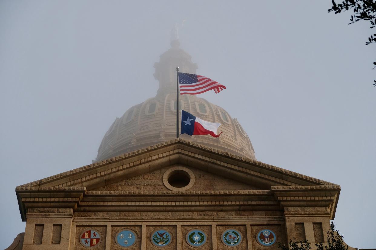 Texas and U.S. flags fly over the Texas State Capitol. (Credit: Ken Herman/American-Statesman/ File)
