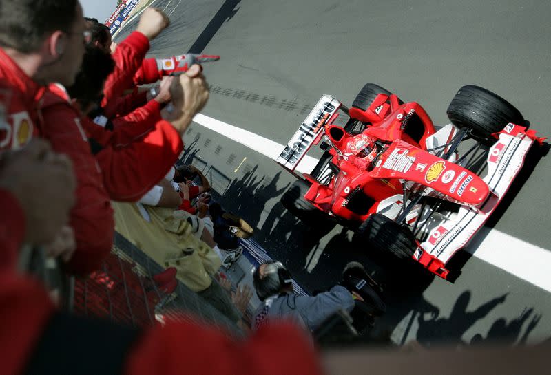 FILE PHOTO: Germany's Michael Schumacher basks in the applause of his Ferrari team as he wins the European Grand Prix.