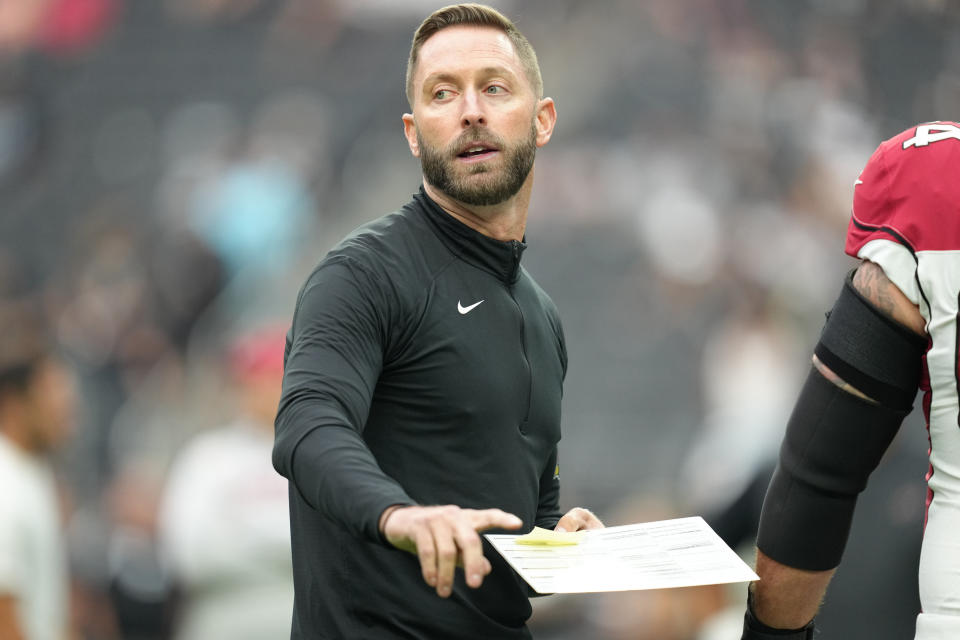 LAS VEGAS, NEVADA - SEPTEMBER 18: Head coach Kliff Kingsbury interacts with players during warmups before a game against the Las Vegas Raiders at Allegiant Stadium on September 18, 2022 in Las Vegas, Nevada. The Cardinals defeated the Raiders 29-23 in overtime. (Photo by Jeff Bottari/Getty Images)