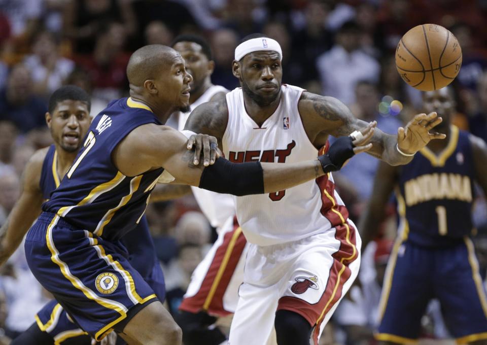 Miami Heat's LeBron James, middle, and Indiana Pacers' David West (21) watch the ball get away during the first half of an NBA basketball game, Friday, April 11, 2014, in Miami. (AP Photo/Lynne Sladky)