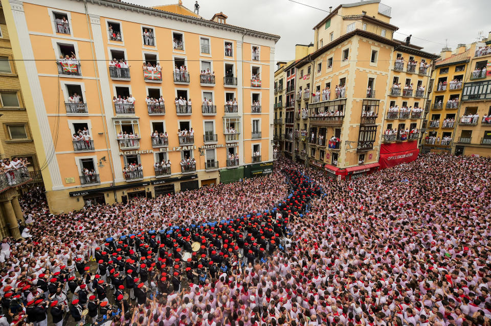 A music band plays in the town hall square after the 'Chupinazo' rocket, to mark the official opening of the 2023 San Fermín fiestas in Pamplona, Spain, Thursday, July 6, 2023. (AP Photo/Alvaro Barrientos)