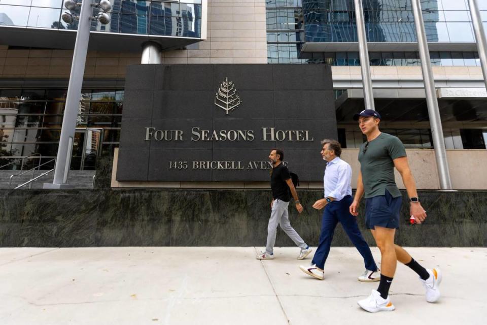 People walk past the Miami Four Seasons hotel on Brickell Avenue on Wednesday, May 24, 2023, as supporters of Gov. Ron DeSantis gather for the start of this campaign for the Republican nomination for president. D.A. Varela dvarela@miamiherald.com