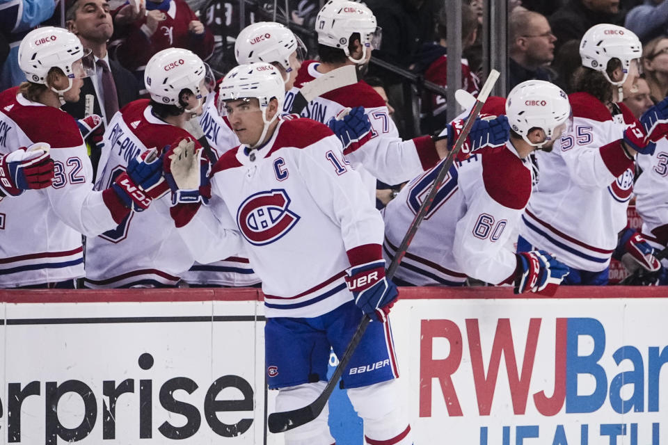 Montreal Canadiens' Nick Suzuki, center, celebrates with teammates after scoring a goal during the second period of an NHL hockey game against the New Jersey Devils Tuesday, Feb. 21, 2023, in Newark, N.J. (AP Photo/Frank Franklin II)