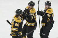 Boston Bruins right wing David Pastrnak (88) celebrates his goal with center Jakub Lauko (94) and left wing Jake DeBrusk (74) after defeating the Columbus Blue Jackets in overtime of an NHL hockey game, Thursday, March 30, 2023, in Boston. (AP Photo/Steven Senne)