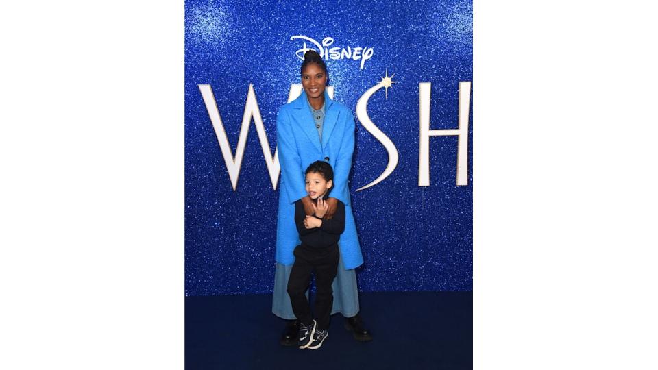 Denise Lewis in blue holding her young son