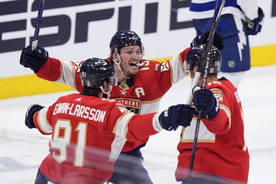 Florida Panthers defenseman Oliver Ekman-Larsson (91) left wing Matthew Tkachuk (19) and center Aleksander Barkov, right, celebrate after Barkov scored during the third period of Game 5 of the first-round of an NHL Stanley Cup Playoff series against the Tampa Bay Lightning, Monday, April 29, 2024, in Sunrise, Fla. (AP Photo/Wilfredo Lee)