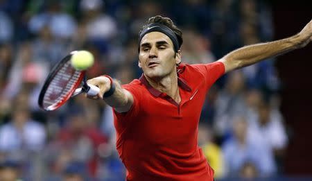 Roger Federer of Switzerland returns a shot during his men's singles semi-final match against Novak Djokovic of Serbia at the Shanghai Masters tennis tournament in Shanghai October 11, 2014. REUTERS/Aly Song