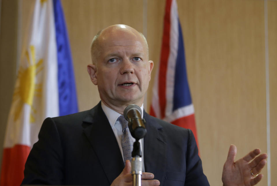 British Foreign Secretary William Hague speaks during a joint news conference with his Philippine counterpart Albert Del Rosario Thursday, Jan. 30, 2014 in Manila, Philippines. Hague said the United Kingdom will take in some refugees from the Syrian conflict to "give them some respite and some care after some of the things that they have been through." (AP Photo/Bullit Marquez)