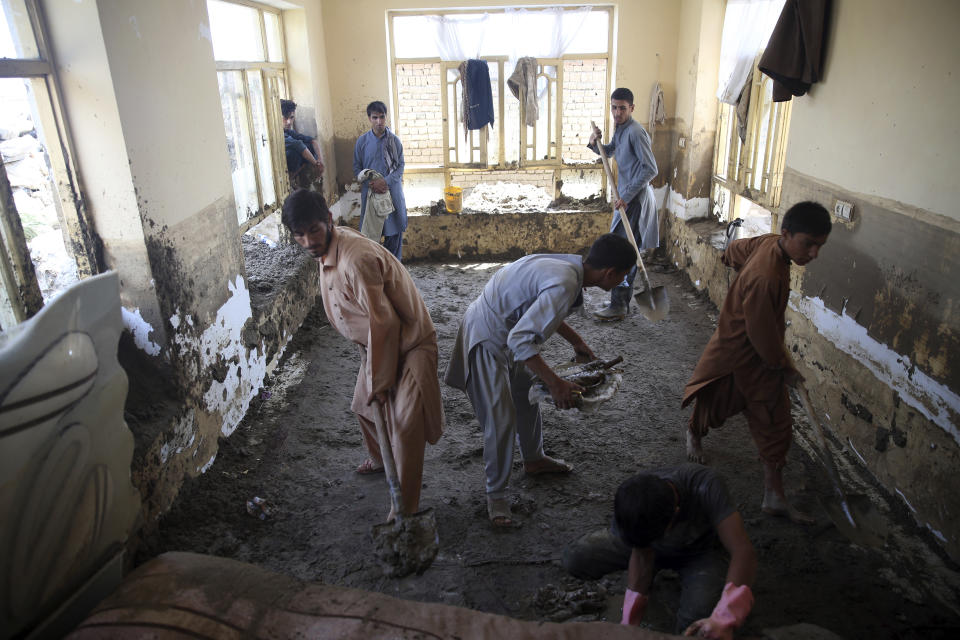 Afghans remove mud from inside their house after a mudslide in Parwan province, north of Kabul, Afghanistan, Thursday, Aug. 27, 2020. The death toll from heavy flooding in northern and eastern Afghanistan rose to at least 150 on Thursday, with scores more injured as rescue crews searched for survivors beneath the mud and rubble of collapsed houses, officials said. (AP Photo/Rahmat Gul)