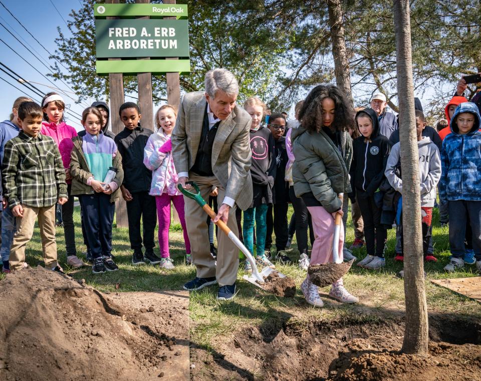 John Erb, son and chair of the Fred A. And Barbara M. Erb Family Foundation, left, helps to plant a tree with Addam's Elementary third grader and chosen tree marshal Sophie Maples, 9, as the Erb family and community honor the late philanthropic Fred Erb on what would have been his 100th birthday by planting 100 trees around the Royal Oak Arboretum on April 27, 2023.